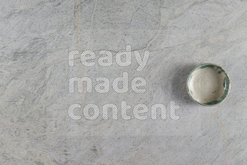 A multicolored pottery Bowl on grey marble background
