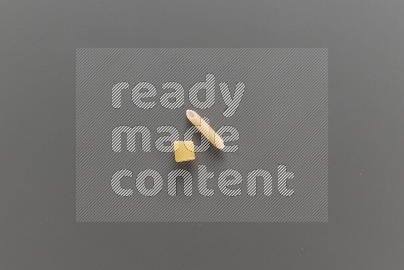 Big rings pasta with other types of pasta on grey background