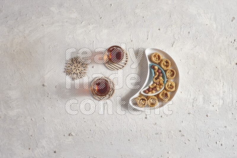 Oriental sweets in a pottery plate with drinks in a light setup