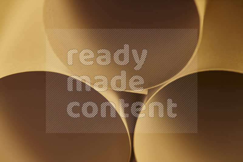 The image shows an abstract paper art with circular shapes in varying shades of gold