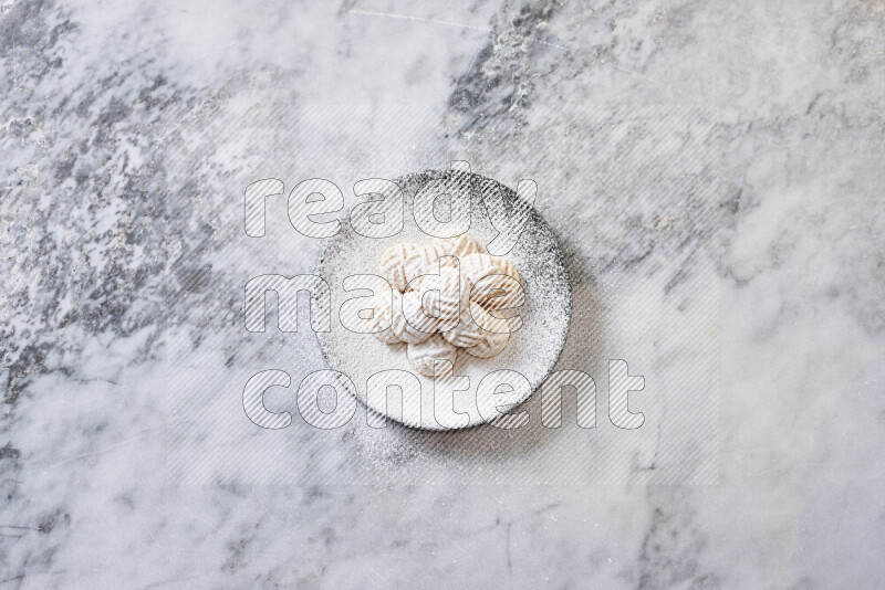 Kahk in black pottery plate on grey marble background