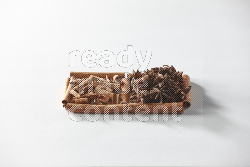2 squares of cinnamon sticks full of star anise and cinnamon on white flooring