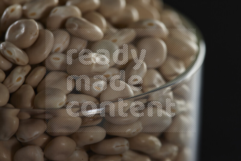Lupin Beans in a glass jar on black background