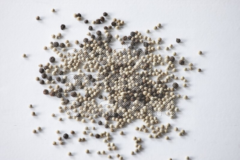 Mixed black and white pepper beads on a white flooring