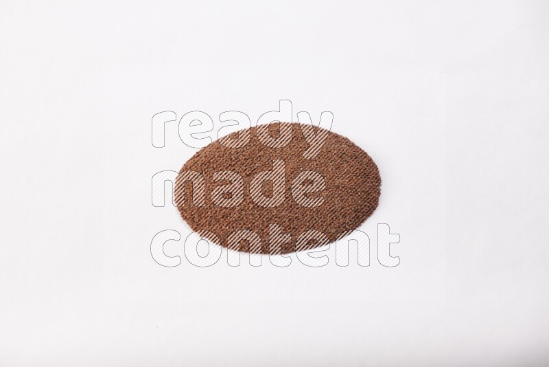 Garden cress seeds in a circle shape on a white flooring