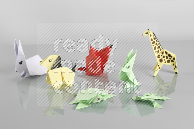Origami animals on grey background
