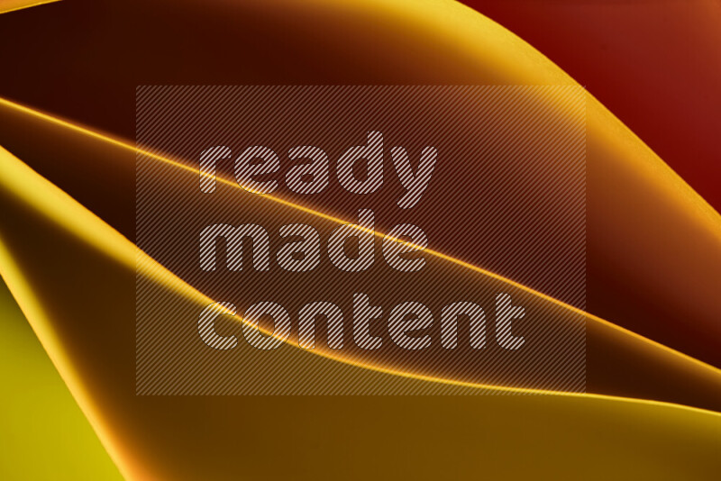 This image showcases an abstract paper art composition with paper curves in yellow, red and brown gradients created by colored light