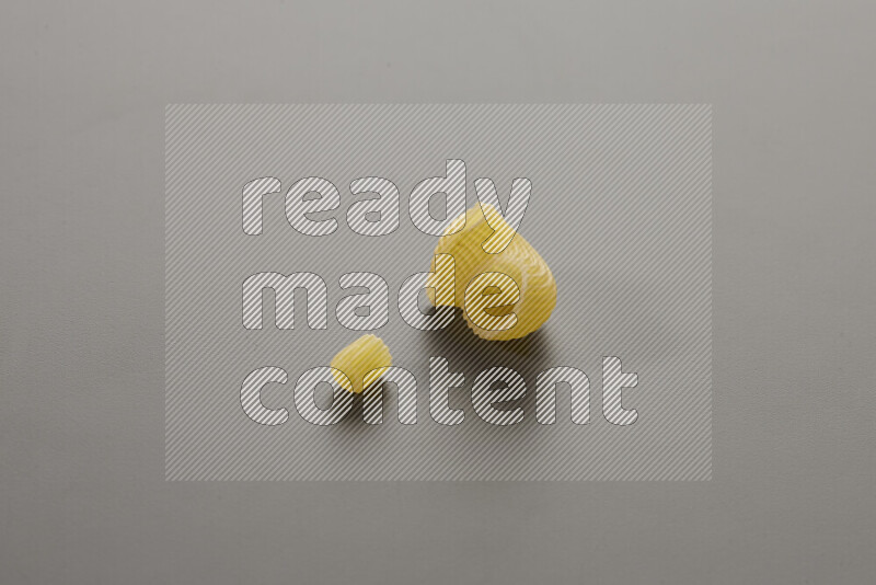 Small rings pasta with other types of pasta on grey background