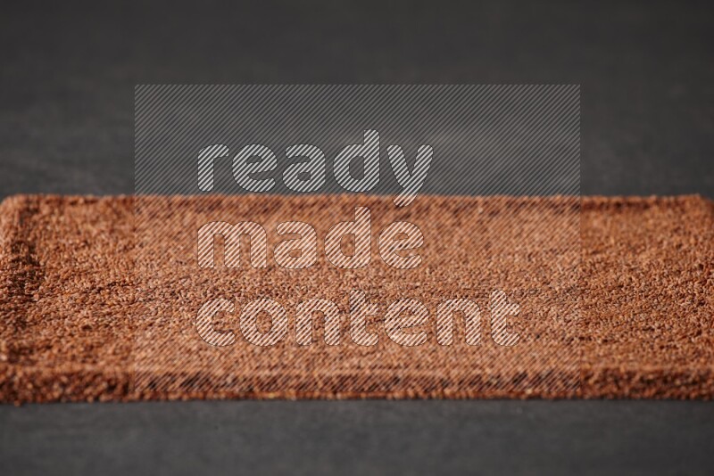 Garden cress seeds filling the frame on a black flooring