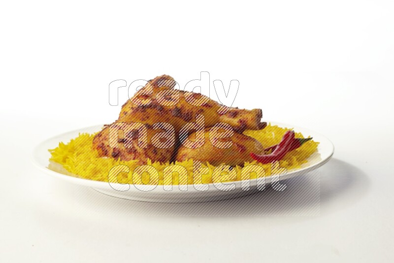 yellow basmati Rice with kabsa chicken pieces on a white rounded plate direct on white background