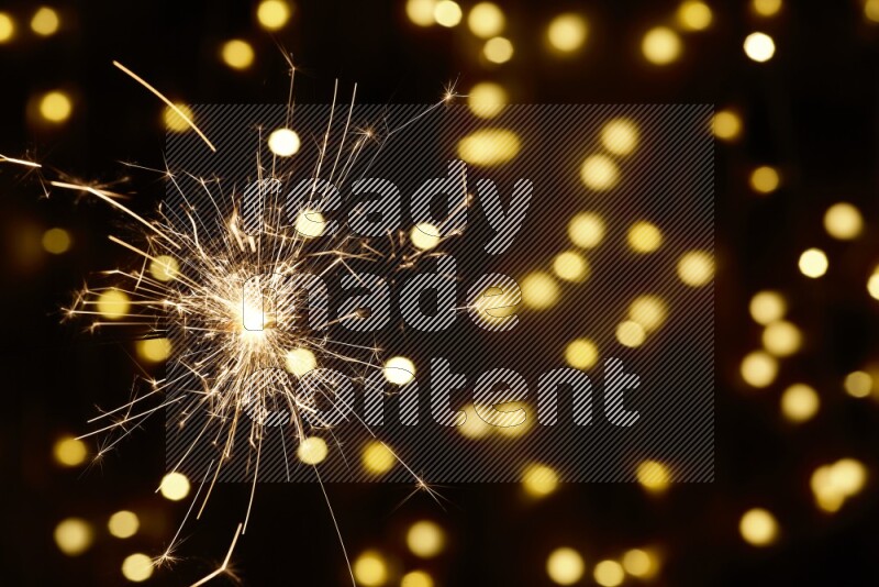 Sparkler candle with yellow light bokeh background
