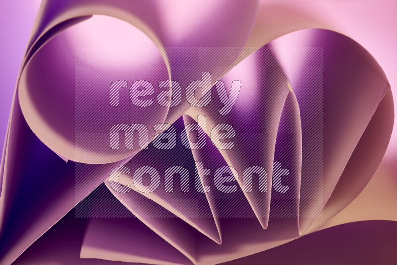 An artistic display of paper folds creating a harmonious blend of geometric shapes, highlighted by soft lighting in purple and warm tones