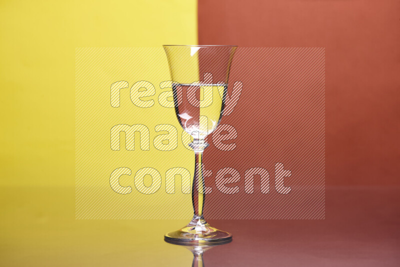 The image features a clear glassware filled with water, set against yellow and dark orange background