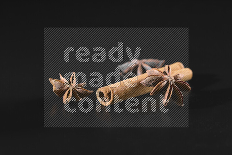 Cinnamon sticks and star anise on black background