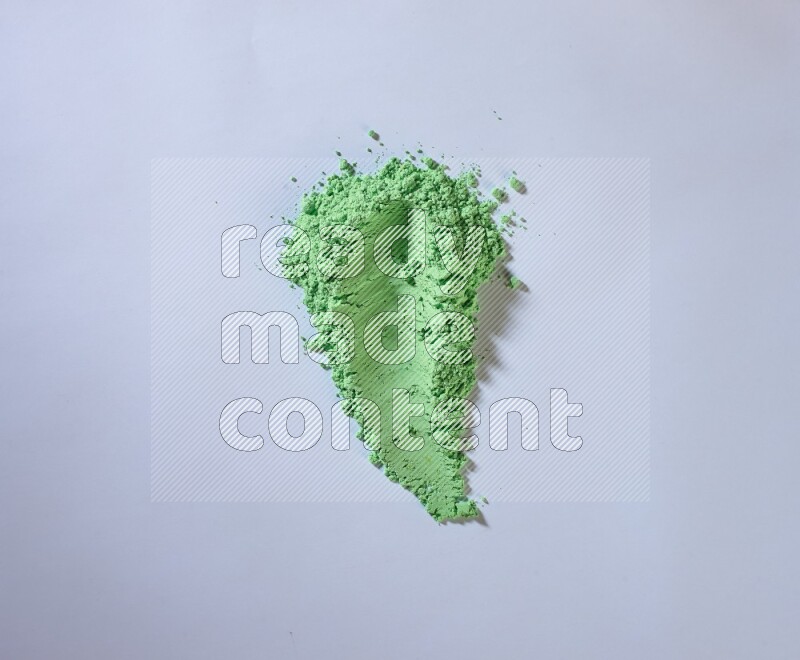 Green powder smears on white background