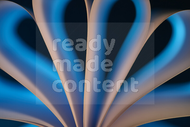 An abstract art piece displaying smooth curves in white and blue gradients created by colored light