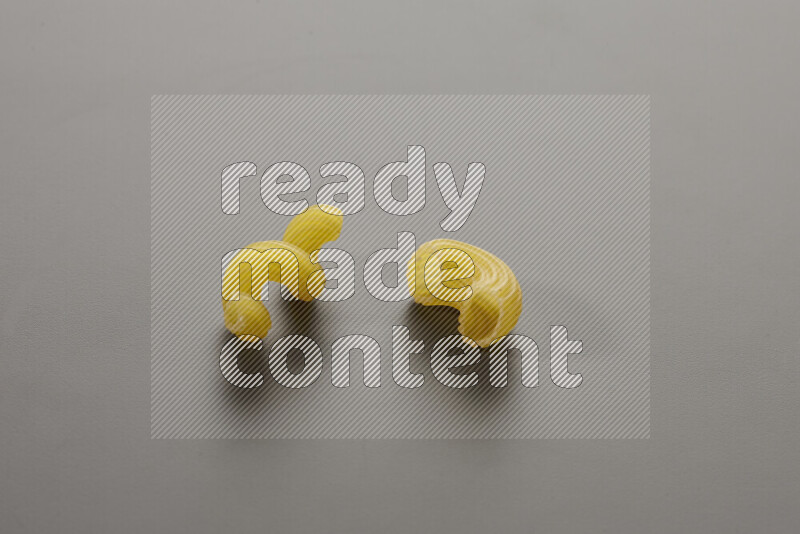 Twist pasta with other types of pasta on grey background