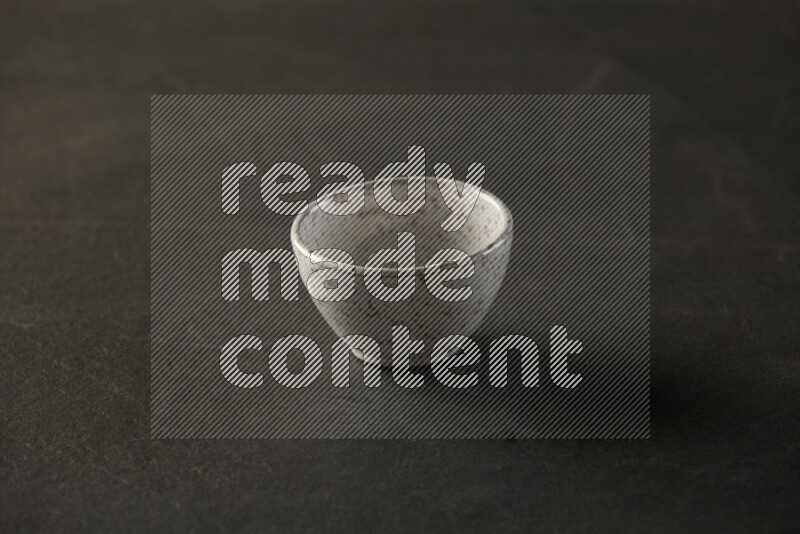 multi color round sauce bowl on grey textured countertop