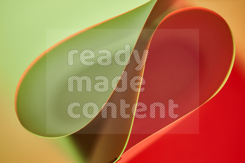 An abstract art of paper folded into smooth curves in green and red gradients