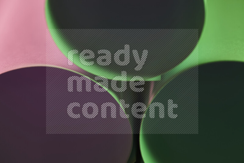 The image shows an abstract paper art with circular shapes in varying shades of green and pink