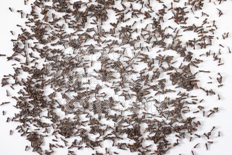 Cloves spread on white flooring