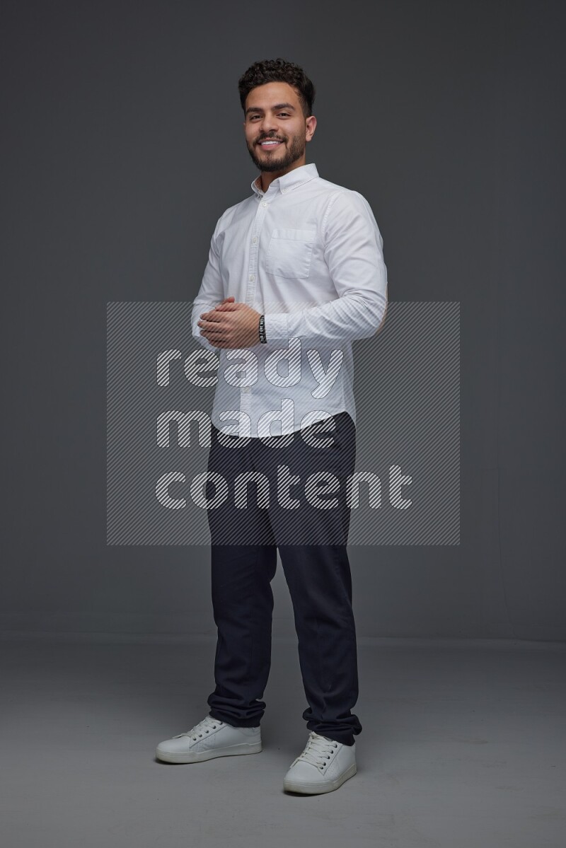 A man wearing smart casual making multi stand poses  eye level on a gray background