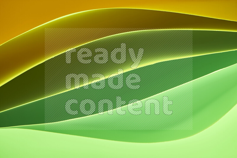 This image showcases an abstract paper art composition with paper curves in green and yellow gradients created by colored light