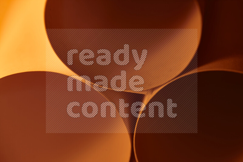 The image shows an abstract paper art with circular shapes in varying shades of orange