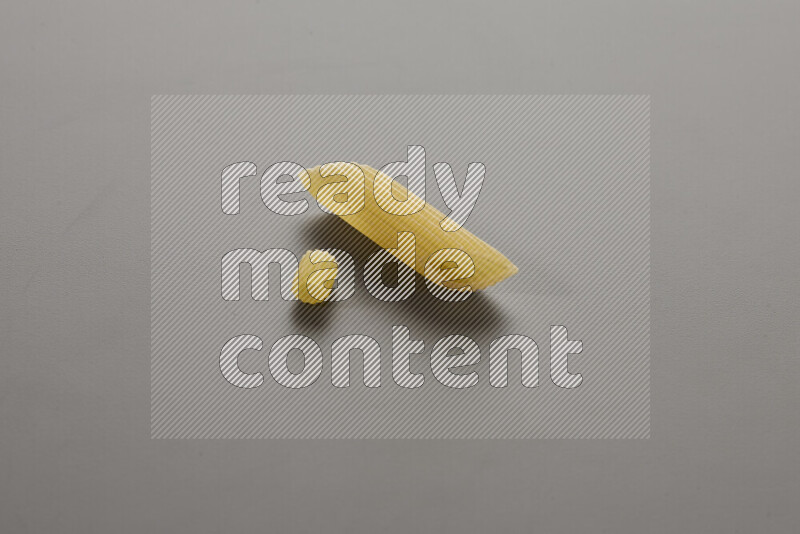 Small rings pasta with other types of pasta on grey background
