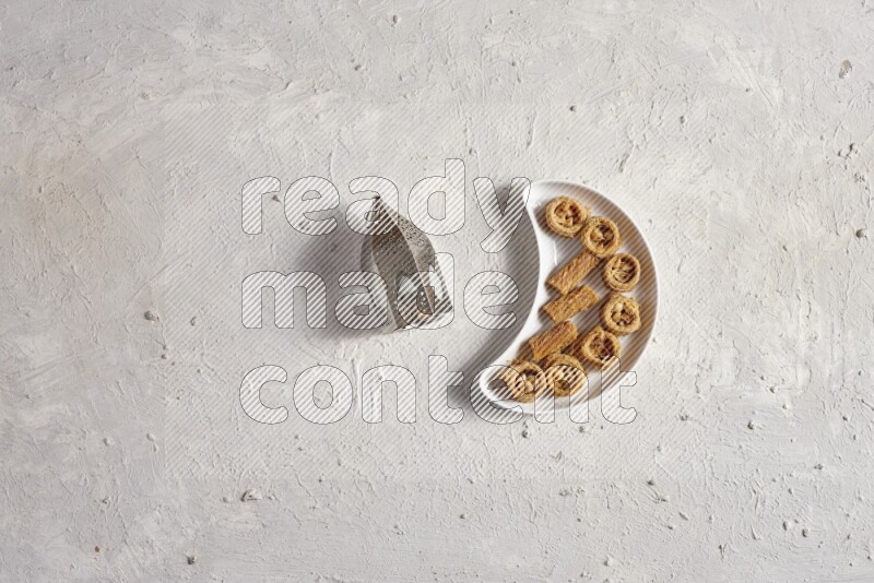 حلويات شرقية في صحن فخاري مع فانوس معدني