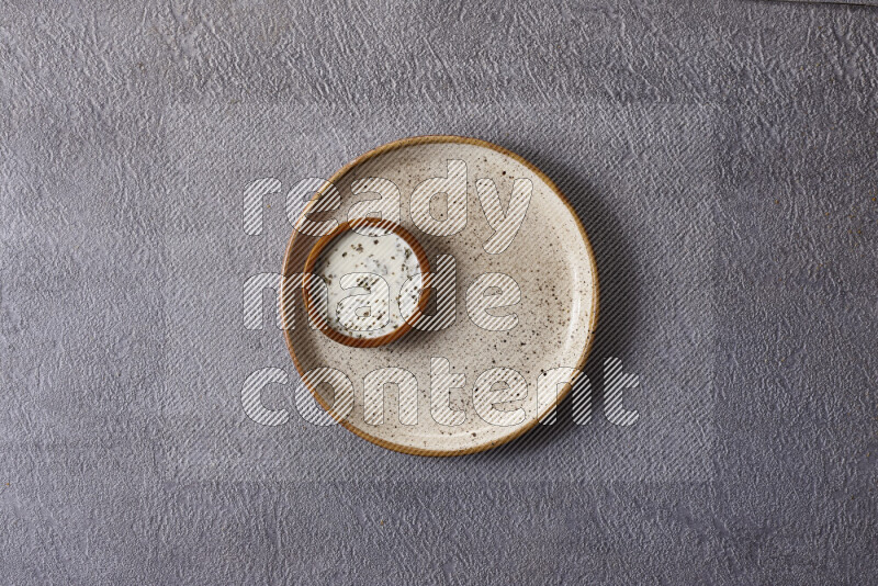 Assorted snacks in pottery bowls on grey background