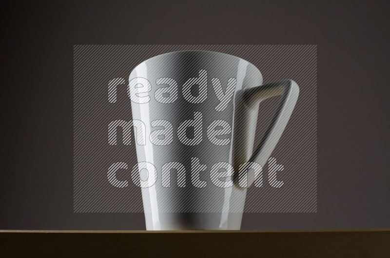 Low angle shot of a white cup on grey background