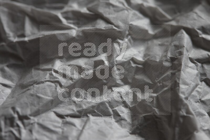 Crumpled notebook sheet on black background