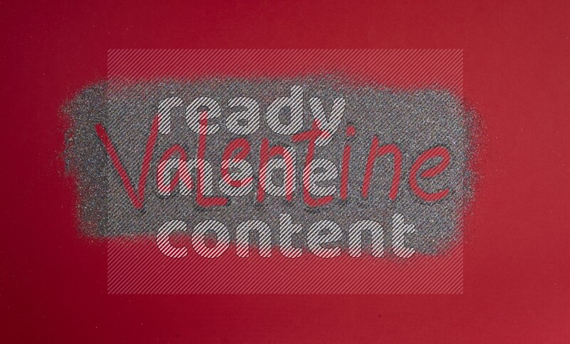A word written with glitter on red background