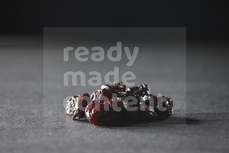 Dried plums on a black background in different angles