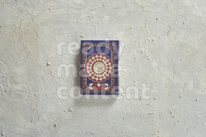 Quran with a prayer beads on white background