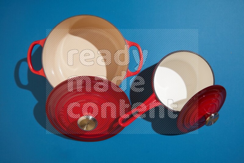 red and white pan and pot on blue background
