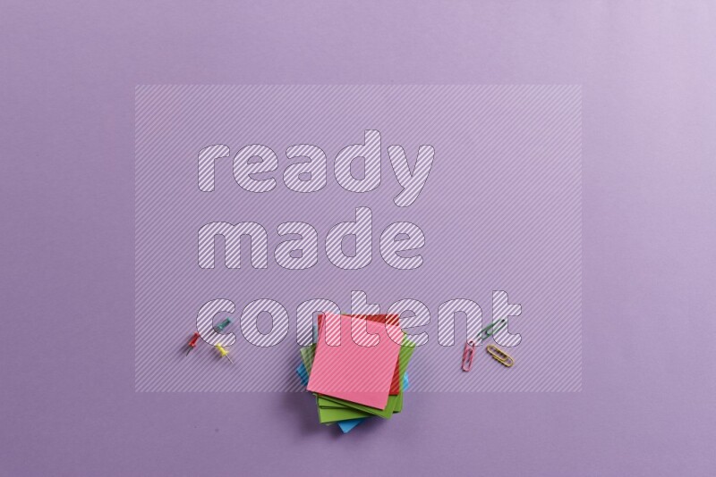 Multicolored sticky notes with school supplies on purple background