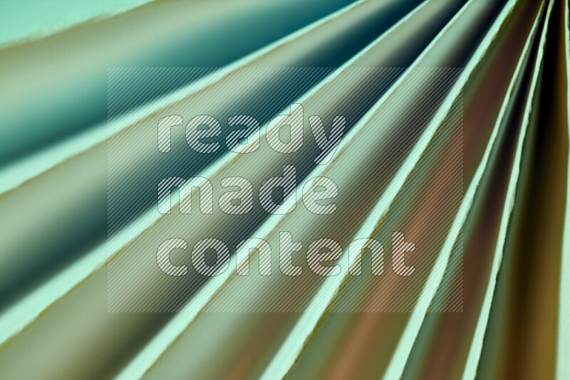 An image presenting an abstract paper pattern of lines in green and gold tones