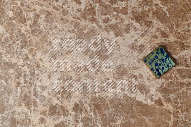 A decorative coaster on beige marble background