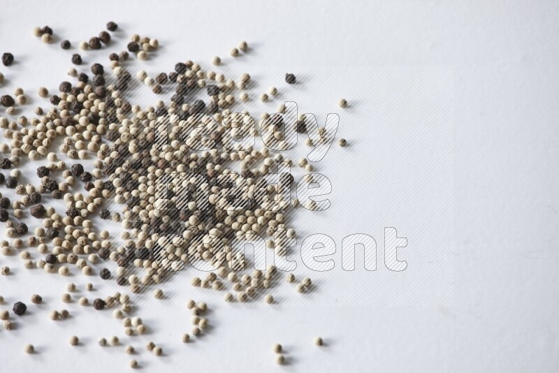 Mixed black and white pepper beads on a white flooring