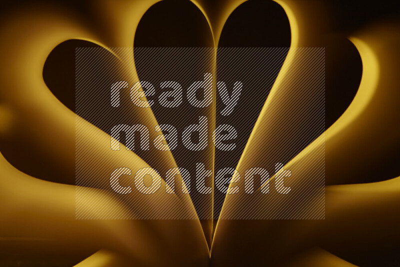 An abstract art piece displaying smooth curves in yellow gradients created by colored light