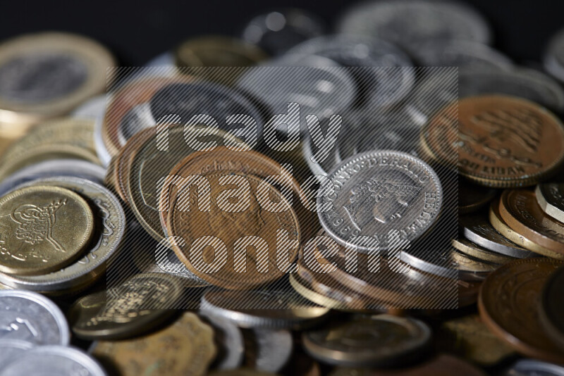 A close-ups of random old coins on black background