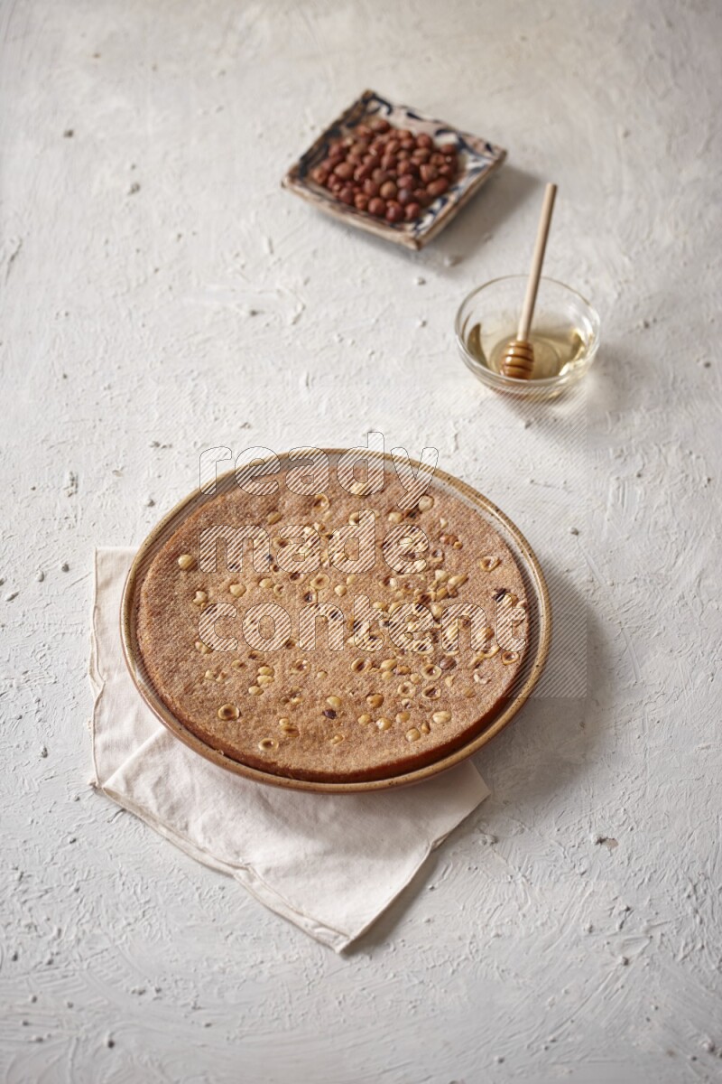 Basbousa with nuts and honey in a light setup