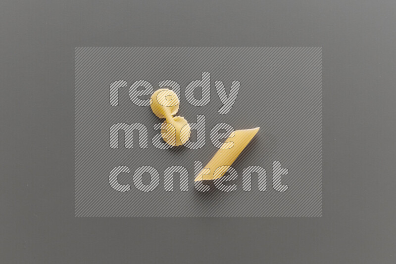 Fiocchi pasta with other types of pasta on grey background