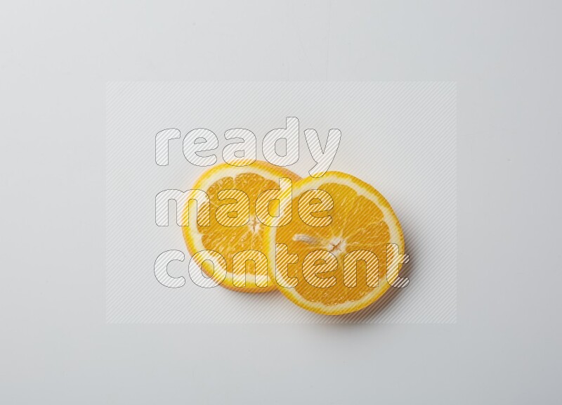 Two orange slices on white background
