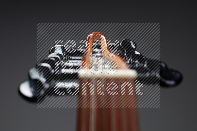 parts of a brown wooden Oud in a gray background