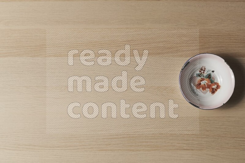 A vintage metal plate on light wooden background