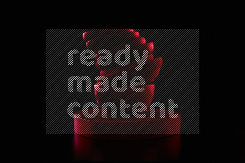 Wooden kitchen essentials with colored rim light against black background