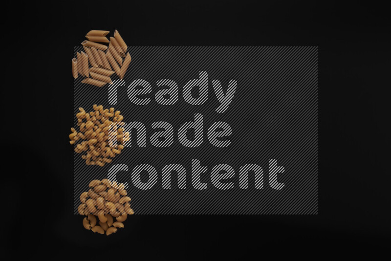 Different pasta types in 3 bunches on black background